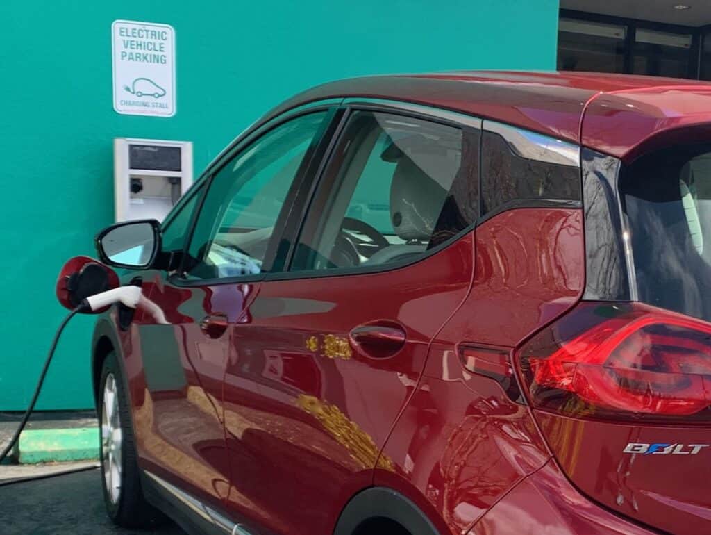 Red Chevy Bolt charging on a level 2 charger